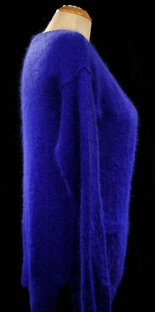 Woman wearing royal blue angora scoop-neck pullover sweater by Victoria's Secret in small-medium size