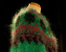 Colorful woman's mohair cardigan sweater with Icelandic design in green, red, and purple tones on a mannequin.