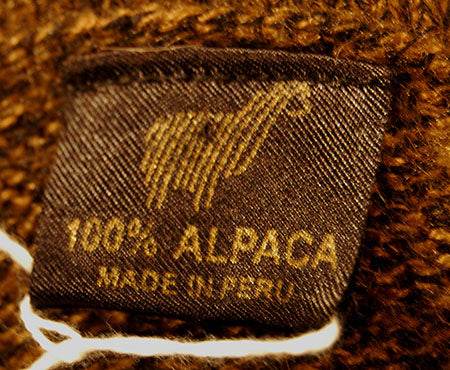 Golden-brown men's alpaca zipper polo-neck sweater with white Aztec design and front pocket, medium size