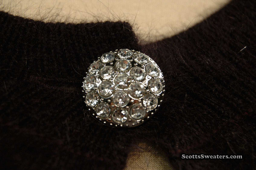 Close-up of jeweled rhinestone button on Woman's Angora Shrug cardigan sweater by Express
