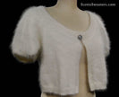 Woman's angora shrug cardigan with jeweled rhinestone button by Express on mannequin