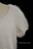 White woman's angora shrug with jeweled rhinestone button by Express on mannequin