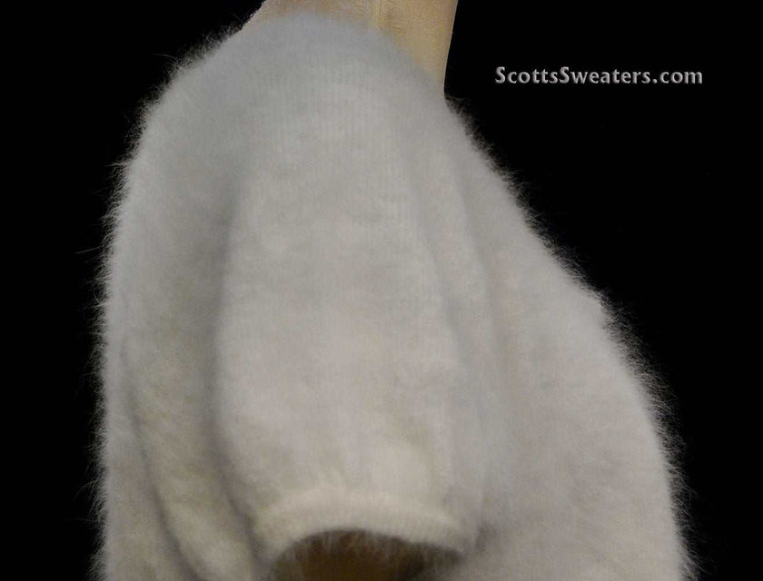 White woman's angora shrug cardigan sweater with jeweled rhinestone button by Express