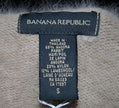 Woman wearing a muted tan Angora scoop neck sweater by Banana Republic in cling-fit design
