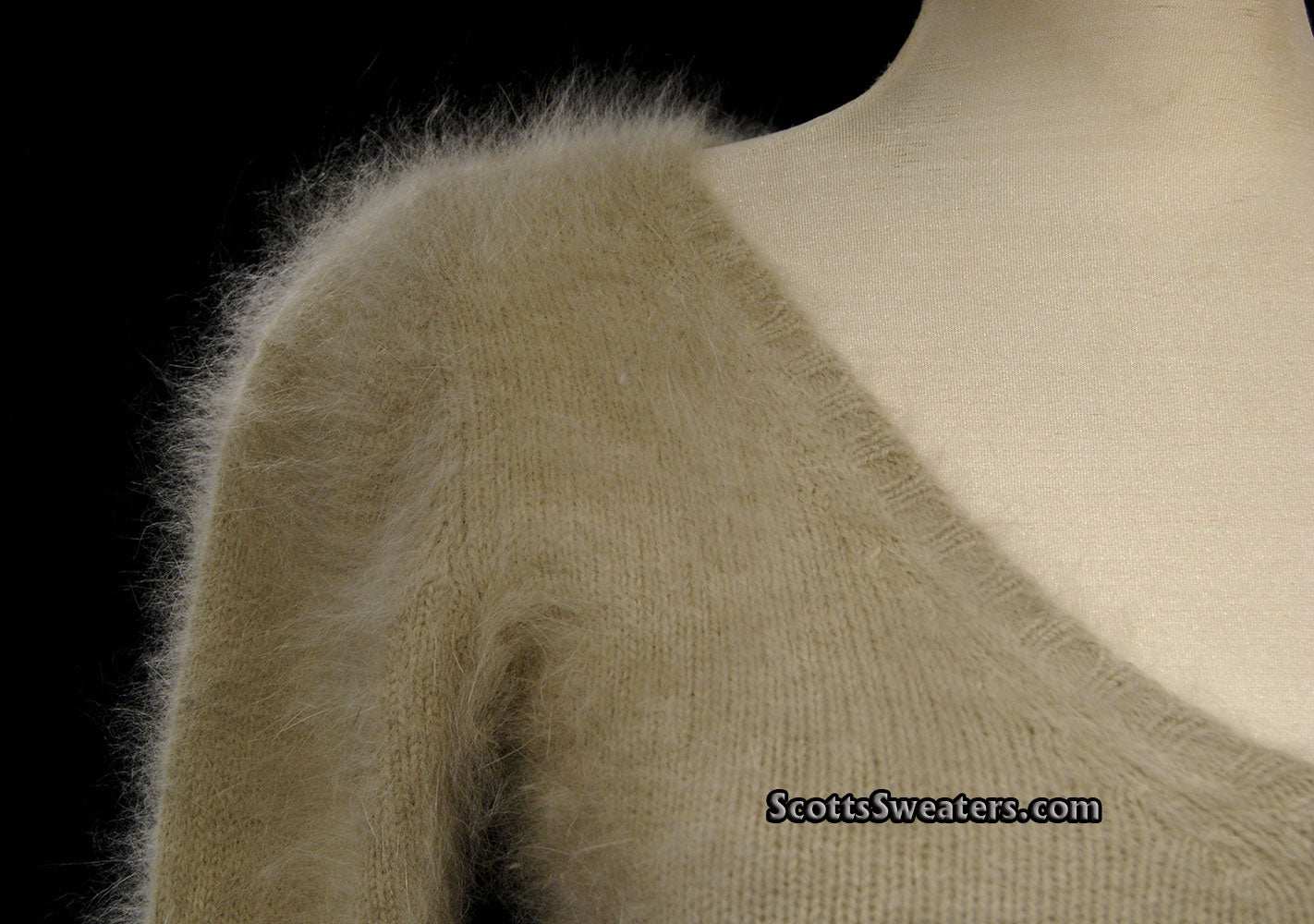Woman wearing a tan Angora scoop neck sweater with cling-fit design by Banana Republic