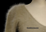 Woman wearing a tan Angora scoop neck sweater with cling-fit design by Banana Republic