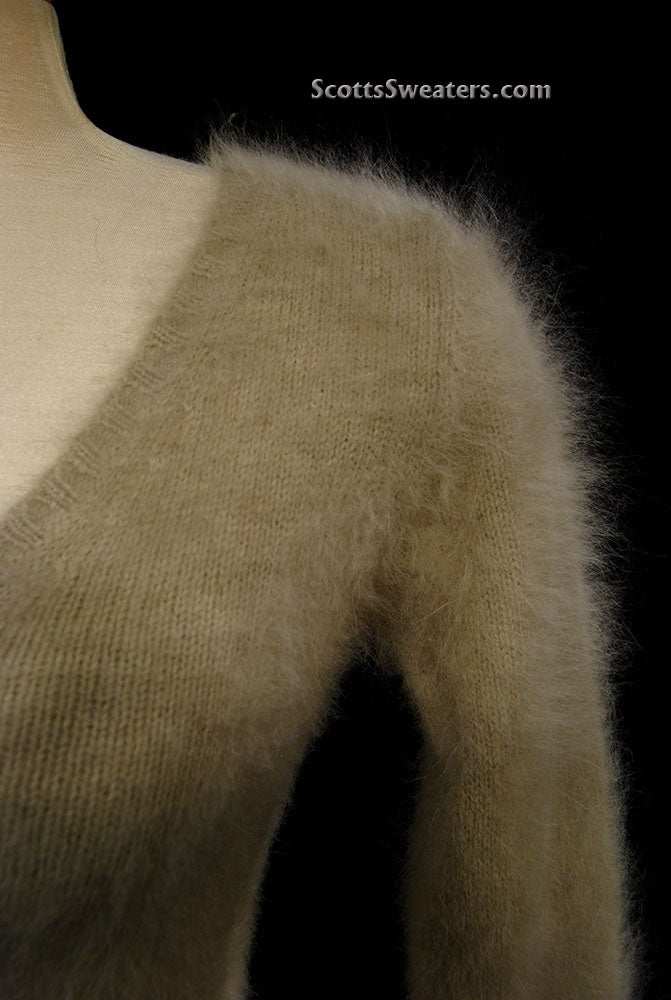Woman wearing a tan Woman's Angora Scoop Neck Sweater by Banana Republic with cling-fit design