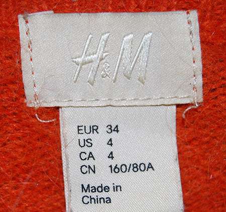 H&M label on orange angora sweater showing size and origin