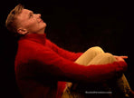 Men wearing ultra-soft red angora turtleneck sweater sitting against black background