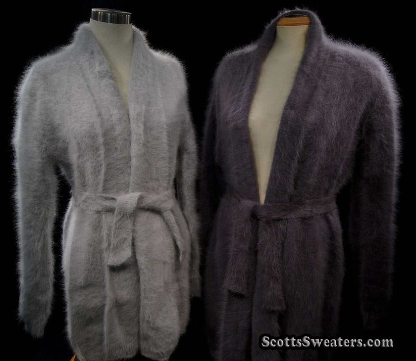 Woman wearing ultra-soft open-front angora cardigan with turn-down collar and lantern sleeves, featuring matching belt closure