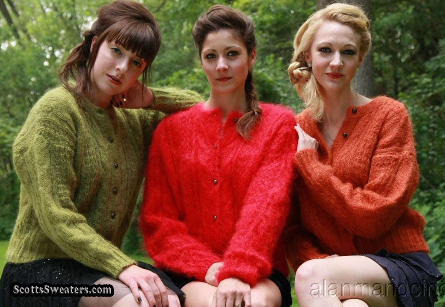 Three women outdoors wearing retro Italian mohair cable-knit cardigans in green, red, and orange colors