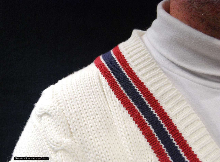 Men's sporty V-neck pullover tennis sweater with red and navy striped trim and cable knit design.