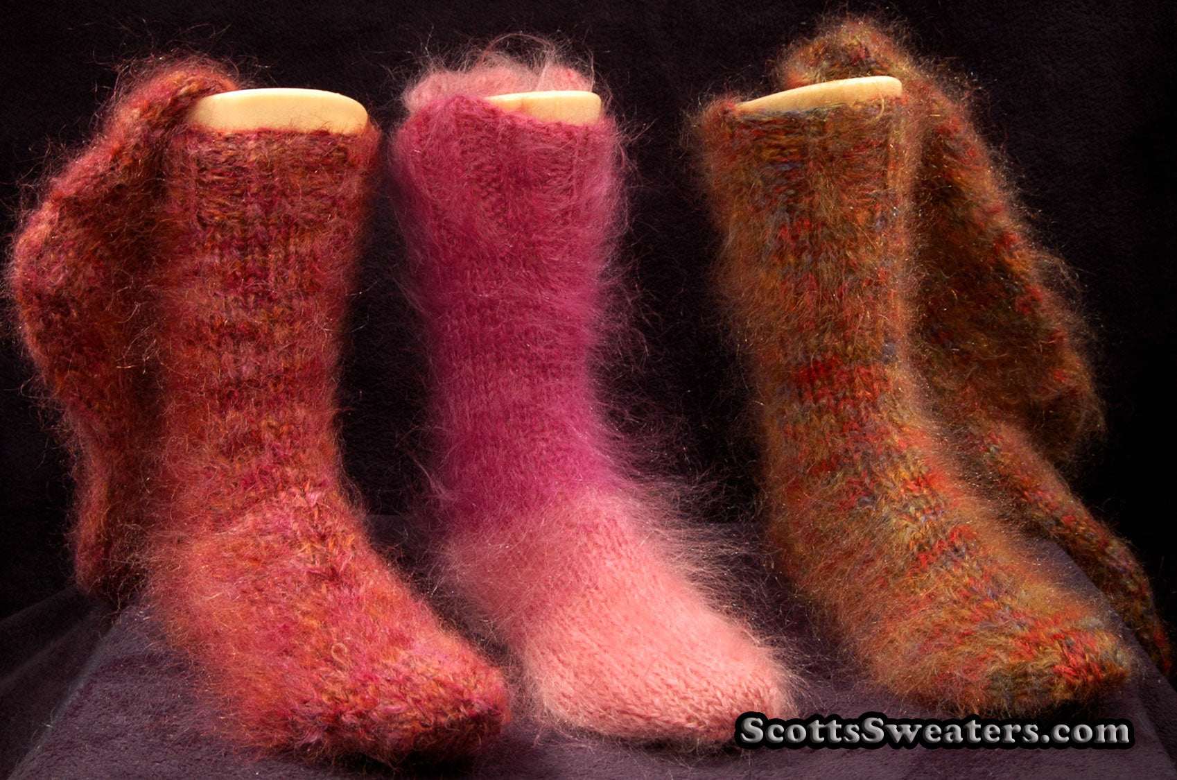 Thick colorful hand-knit mohair socks in warm red, pink, and orange tones