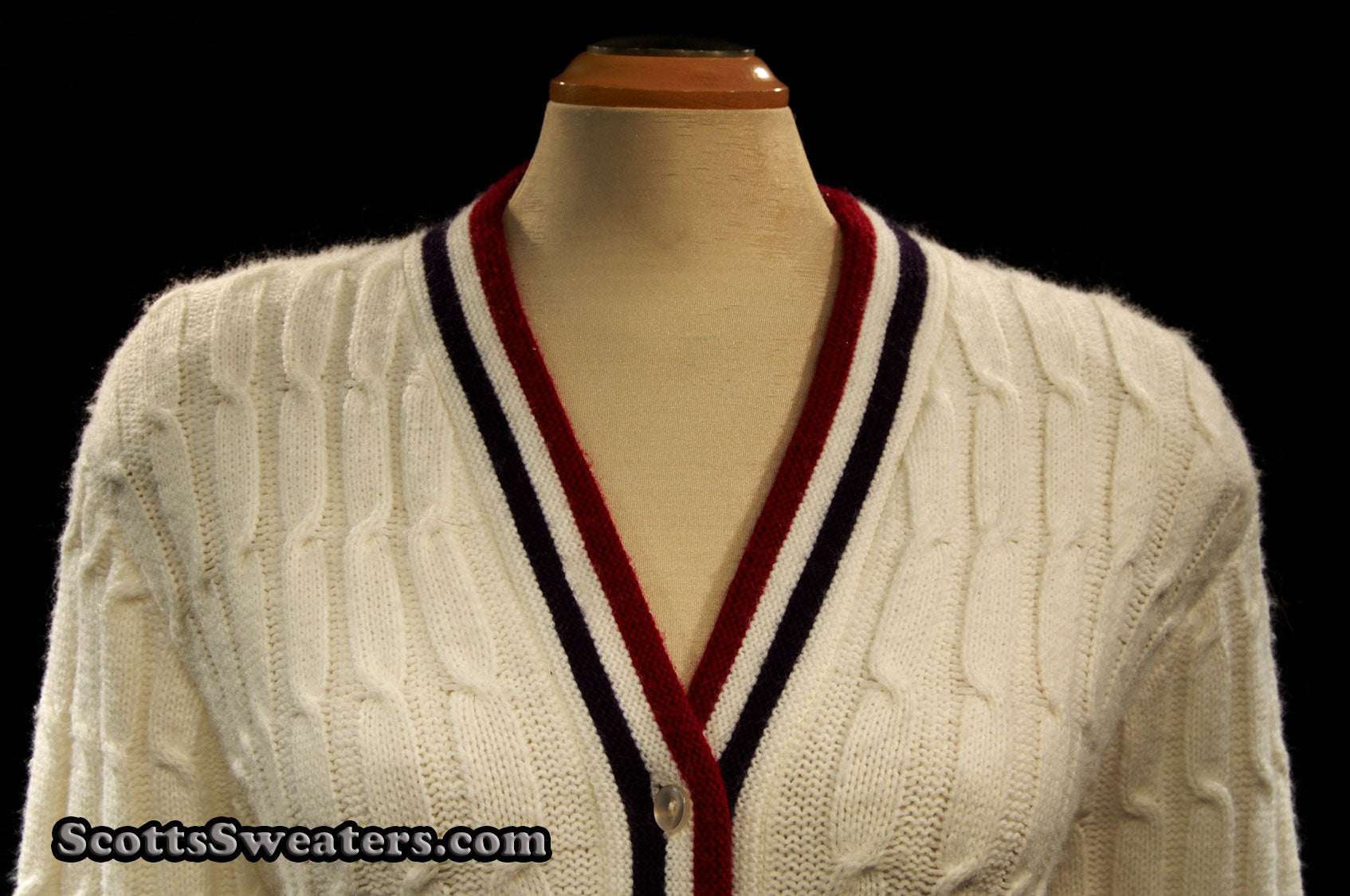 Woman's retro white cable-knit cardigan sweater with red and blue trim stripes, size x-small