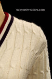 Woman's retro white cable-knit cardigan tennis sweater with red and blue trim stripes on collar, size x-small