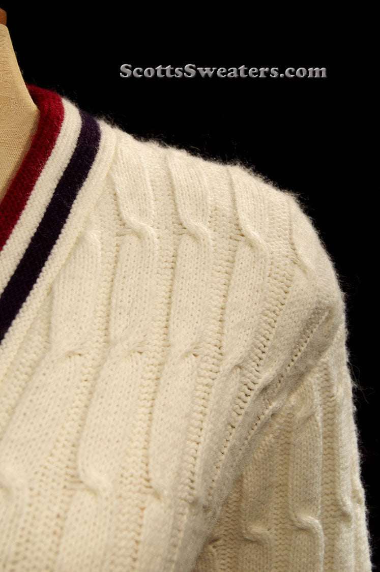 Woman's retro white cable-knit cardigan tennis sweater with red and blue trim stripes on collar, size x-small