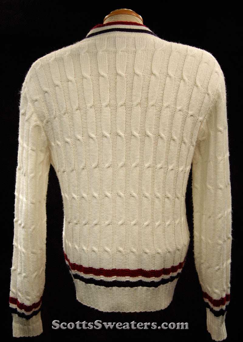 White cable-knit woman's retro cardigan sweater with red and blue trim stripes, size x-small