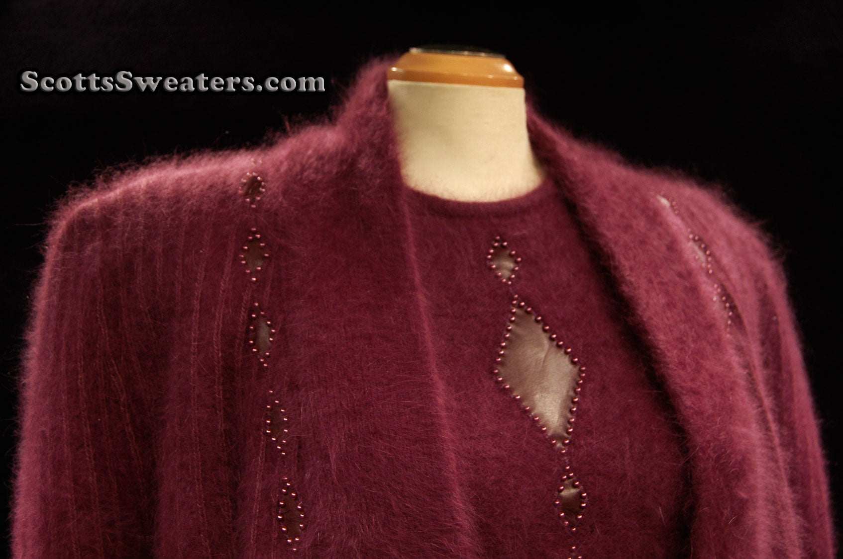 Woman's 2-piece matching deep-purple Angora sweater set with short-sleeve top and open-front cardigan featuring leather appliqué