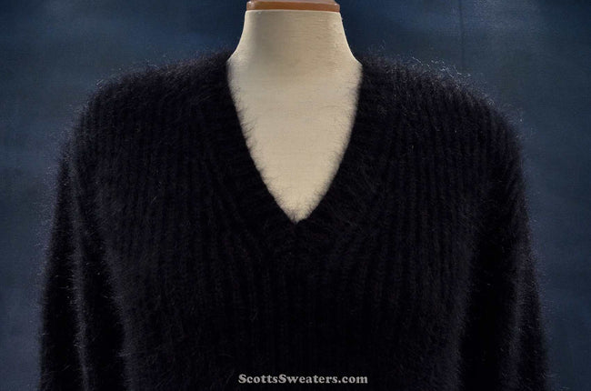 Women's black V-neck angora sweater by Michael Kors displayed on mannequin
