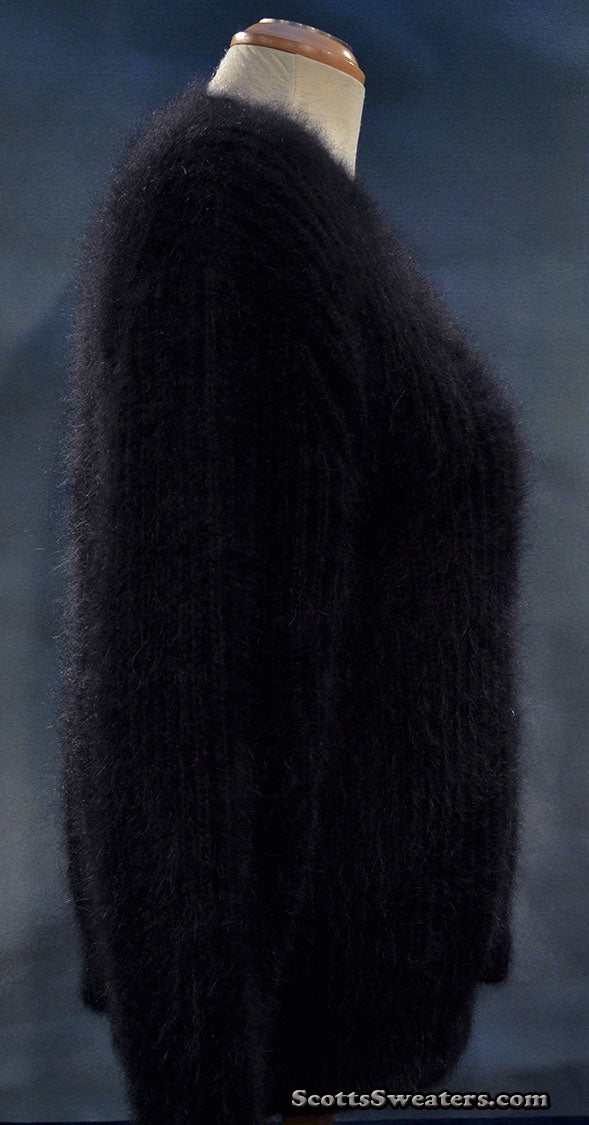 Woman's black V-neck angora sweater by Michael Kors displayed on mannequin against dark background