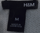 H&M label on woman's white angora medium size sweater made in Cambodia