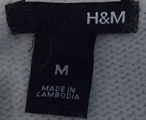 H&M label on woman's white angora medium size sweater made in Cambodia
