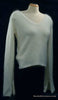 Woman's white angora V-neck sweater with split cuffs by H&M on mannequin