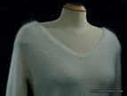 Woman's white angora V-neck sweater with split cuffs by H&M on mannequin