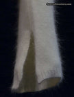 close-up of woman's white angora sweater sleeve with split cuffs and V-neck design