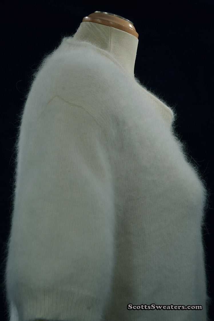 Woman wearing white short-sleeved V-neck angora sweater by Just Clothes