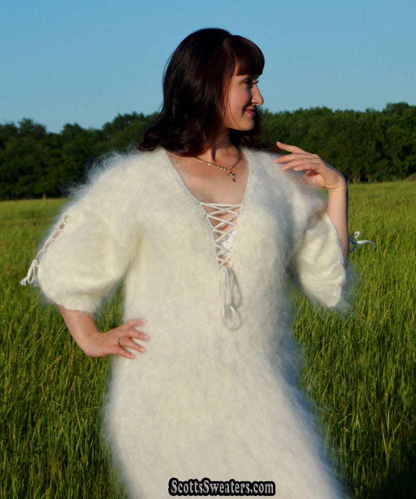 Ivory fuzzy mohair sweaterdress with open-lace neckline and half sleeves worn outdoors
