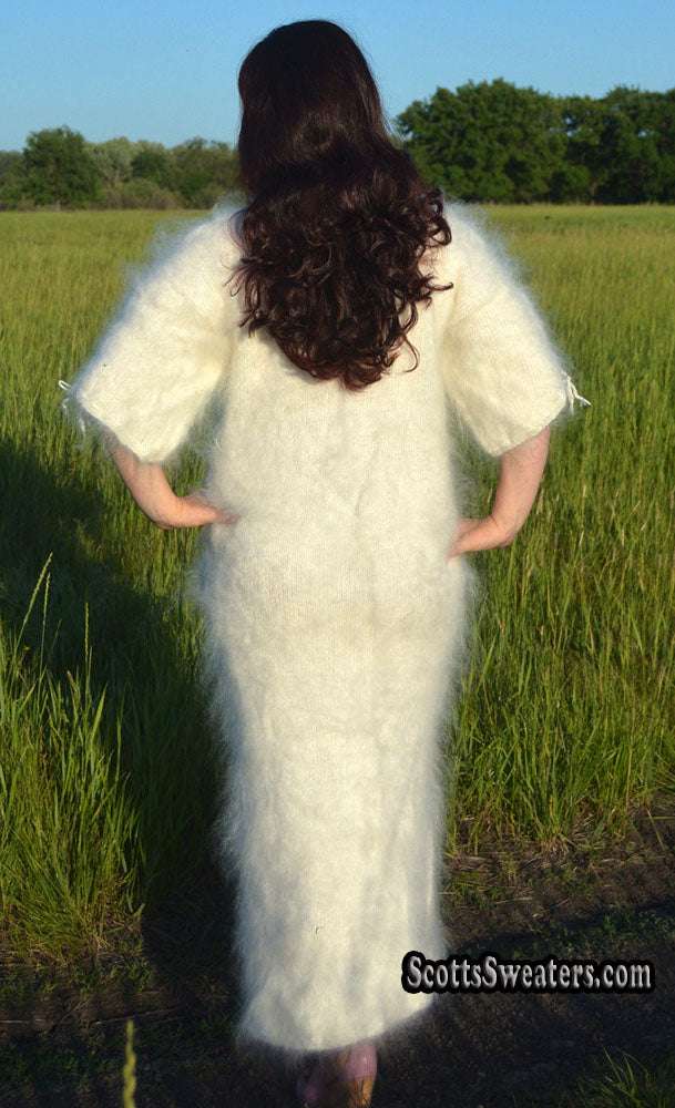 Ivory fuzzy mohair full-length sweaterdress with half-sleeves and slit bottom viewed from back in outdoor field