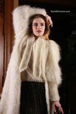 Woman wearing ivory full-length mohair sweater-coat by Ann Arundell in the UK