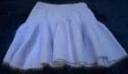 Soft light purple woman's short angora skirt with elastic waistband on dark background