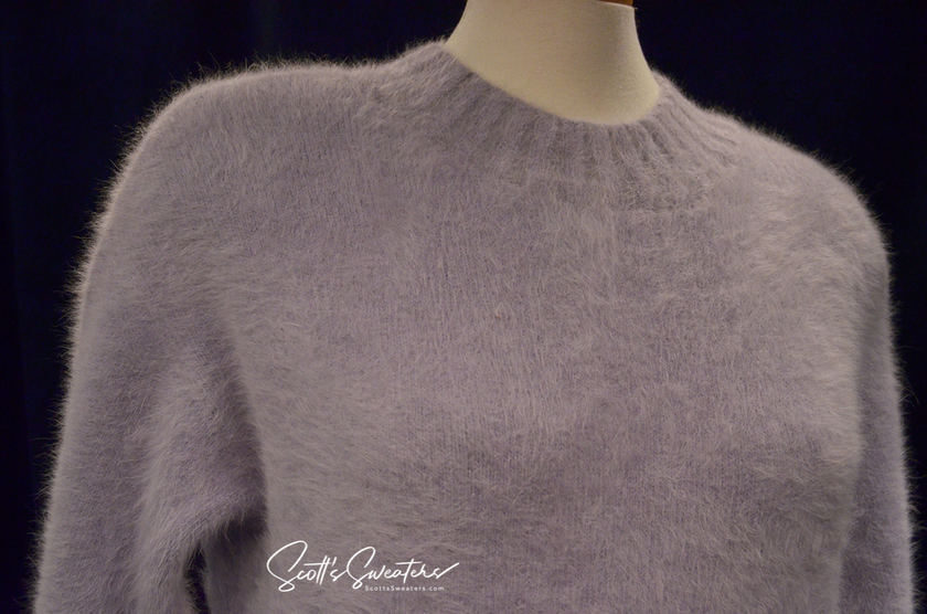 Light-blue angora fuzzy crewneck sweaterdress on mannequin in soft light bluish-grey shade