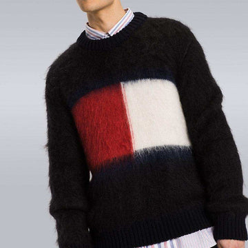 Men's black Tommy Hilfiger mohair crewneck sweater with large red, white, and navy flag logo on chest