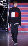 Black crewneck Tommy Hilfiger mohair sweater with large red, white, and blue flag logo on chest
