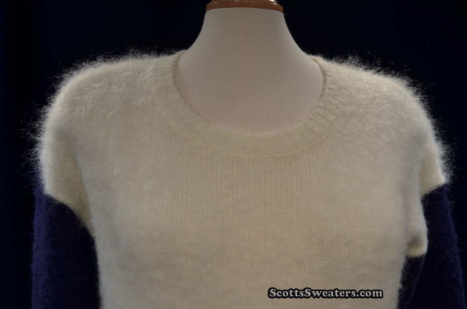 White fuzzy roundneck mohair color-block sweater with navy sleeves on mannequin
