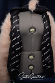 Punk style thick and fluffy faux-fur jacket with zipper front, hanging straps, metal D-rings, mohawk hood, and bold printed nylon lining.