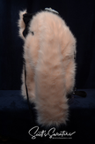Punk style thick and fluffy faux-fur jacket with zipper front, hanging straps, and metal D-rings on cuffs, featuring a Mohawk hood design.