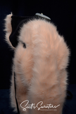 Punk style thick and fluffy faux-fur jacket with zipper front, hanging straps, metal D-rings, and Mohawk hood design.