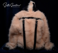 Punk style thick fluffy faux-fur jacket with hood, hanging straps, and metal D-rings on cuffs.
