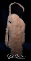 Punk style thick and fluffy faux-fur jacket with zipper front, hanging straps, metal D-rings on cuffs, and mohawk hood design