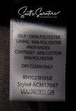 Punk style thick and fluffy faux-fur jacket care label with fabric composition and dry clean instructions