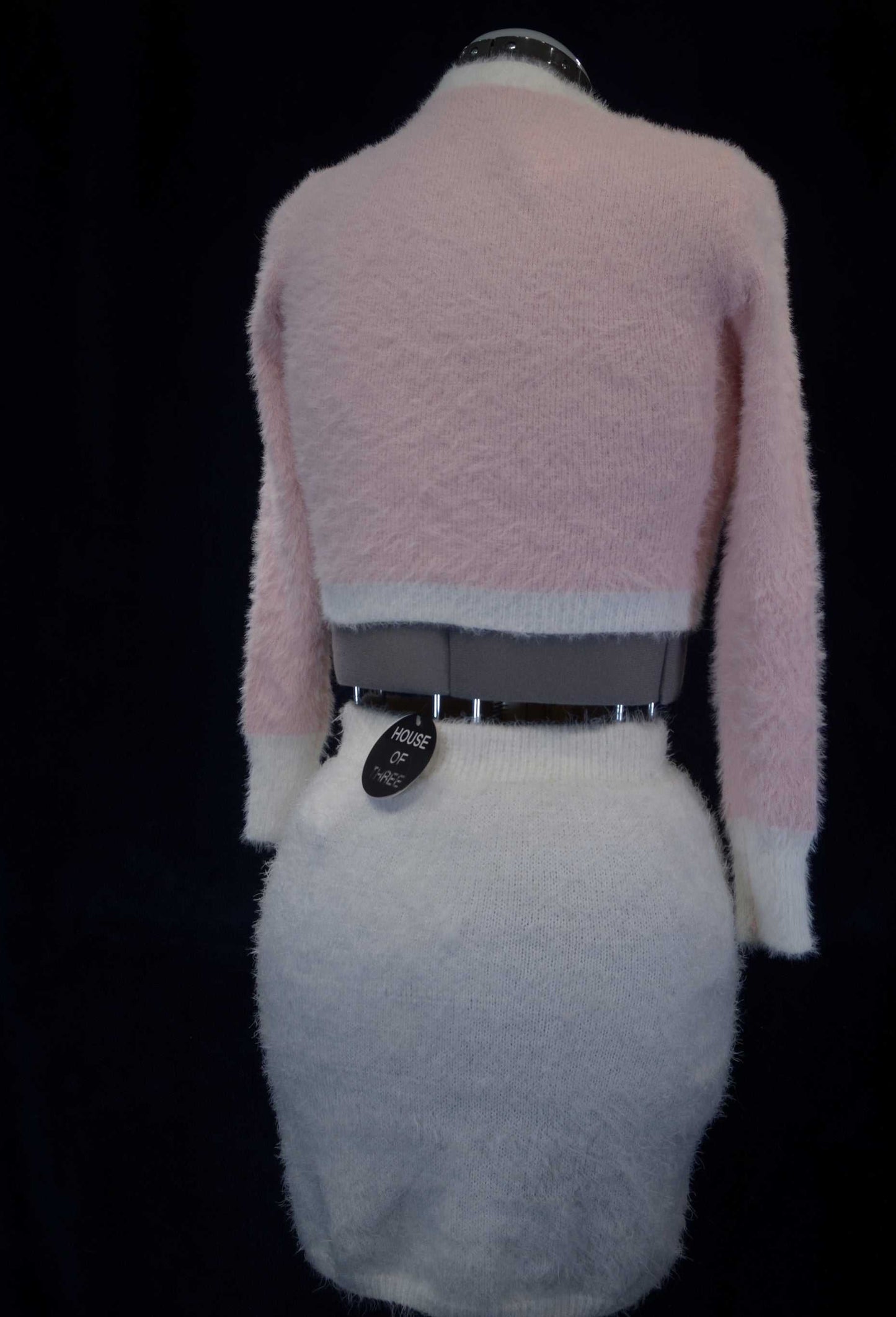 Soft and fuzzy pink and white plush cardigan sweater for girls or women displayed on a mannequin back view
