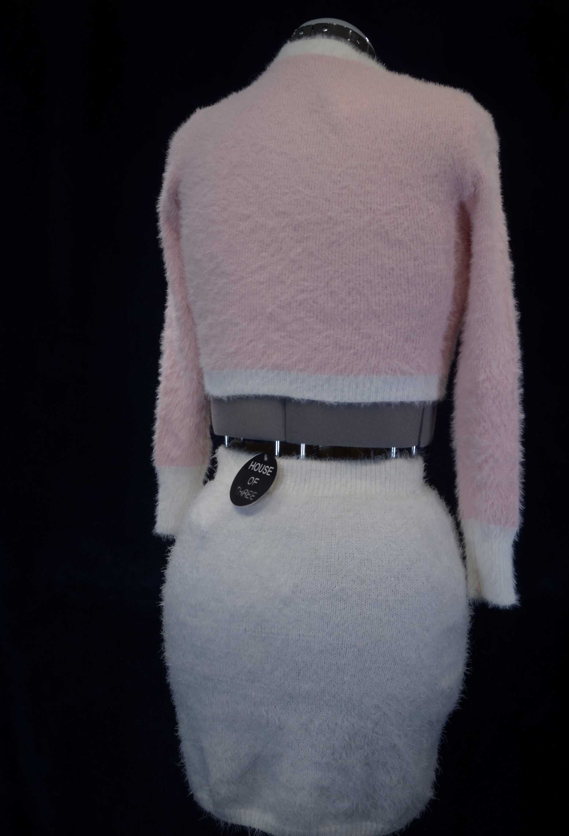 Soft and fuzzy pink and white plush cardigan sweater for girls or women displayed on a mannequin back view