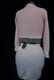 Soft and fuzzy pink and white plush cardigan sweater for girls or women displayed on a mannequin back view
