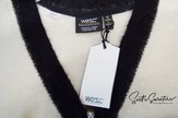 Close-up of WeSC skateboarder street wear mohair cardigan sweater with black trim and white tag, size medium.