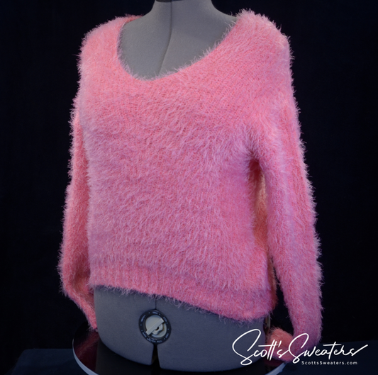 Woman's fuzzy hot-pink plush eyelash V-neck sweater on mannequin