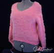 Woman's fuzzy hot-pink plush eyelash V-neck sweater on mannequin